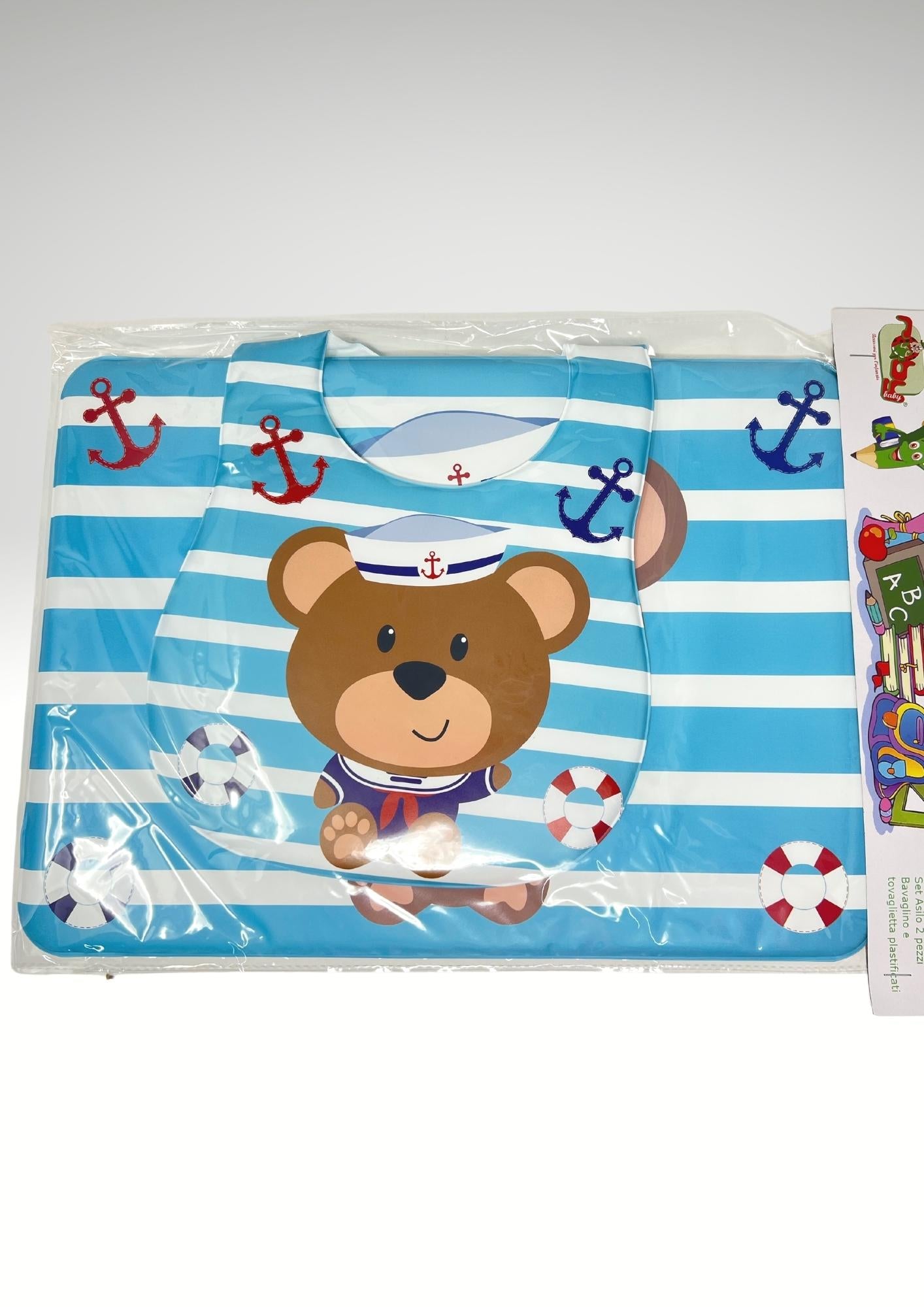 Roby Set Asilo 2pezzi (bavetta+tovaglietta) In Pvc Stampato Colori Assortiti Art. B3405